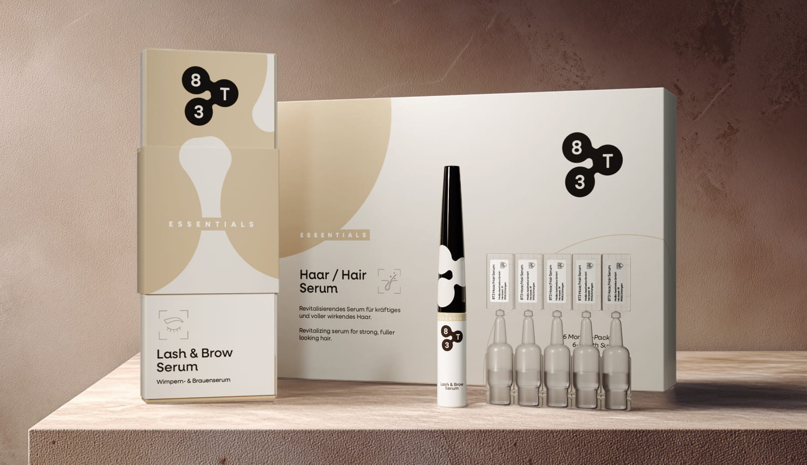 Product display on stone: 8T3 Lash & Brow Serum next to large hair serum box and five single-dose ampoules